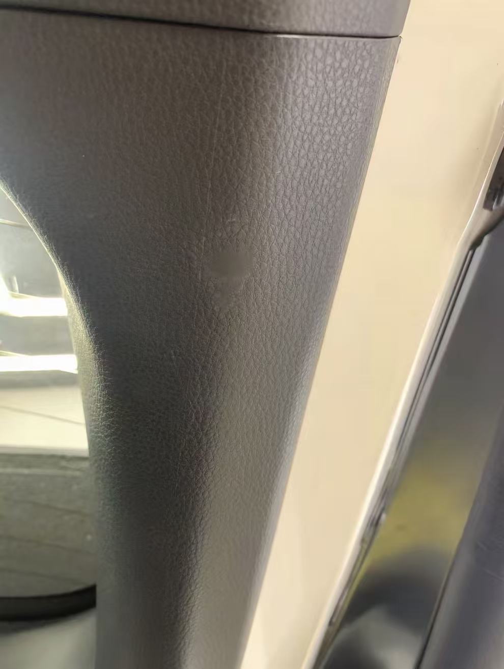Interior Pillar Trim Restoration — Before: The affected area on the textured interior pillar trim before repair.
