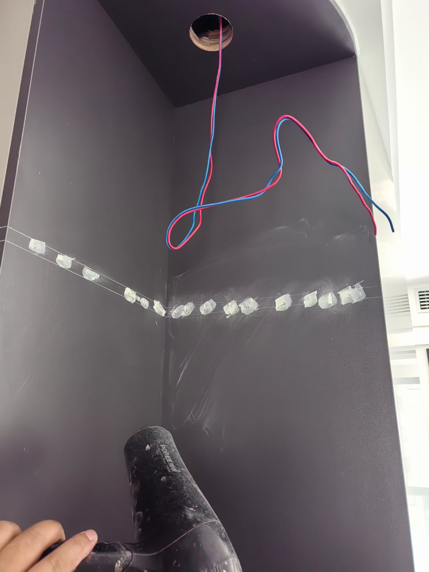 Cabinet Panel Surface Restoration — In Progress: Filled areas on the cabinet panels during surface repair.