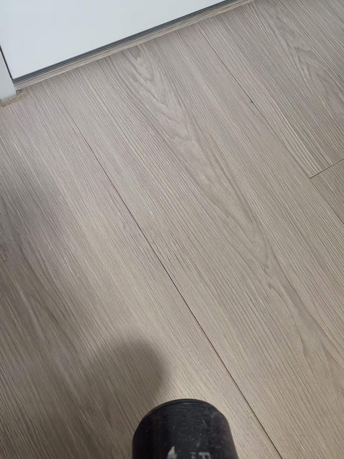 Wood-Grain Floor Scratch Repair — After: The same flooring area after scratch repair.