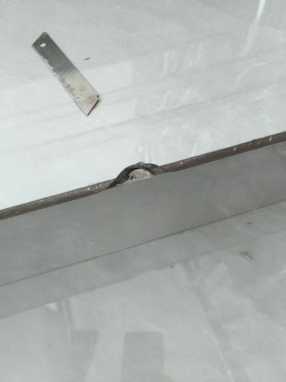 Stone Step Edge Repair — Before: A chipped edge on a stone step before repair.