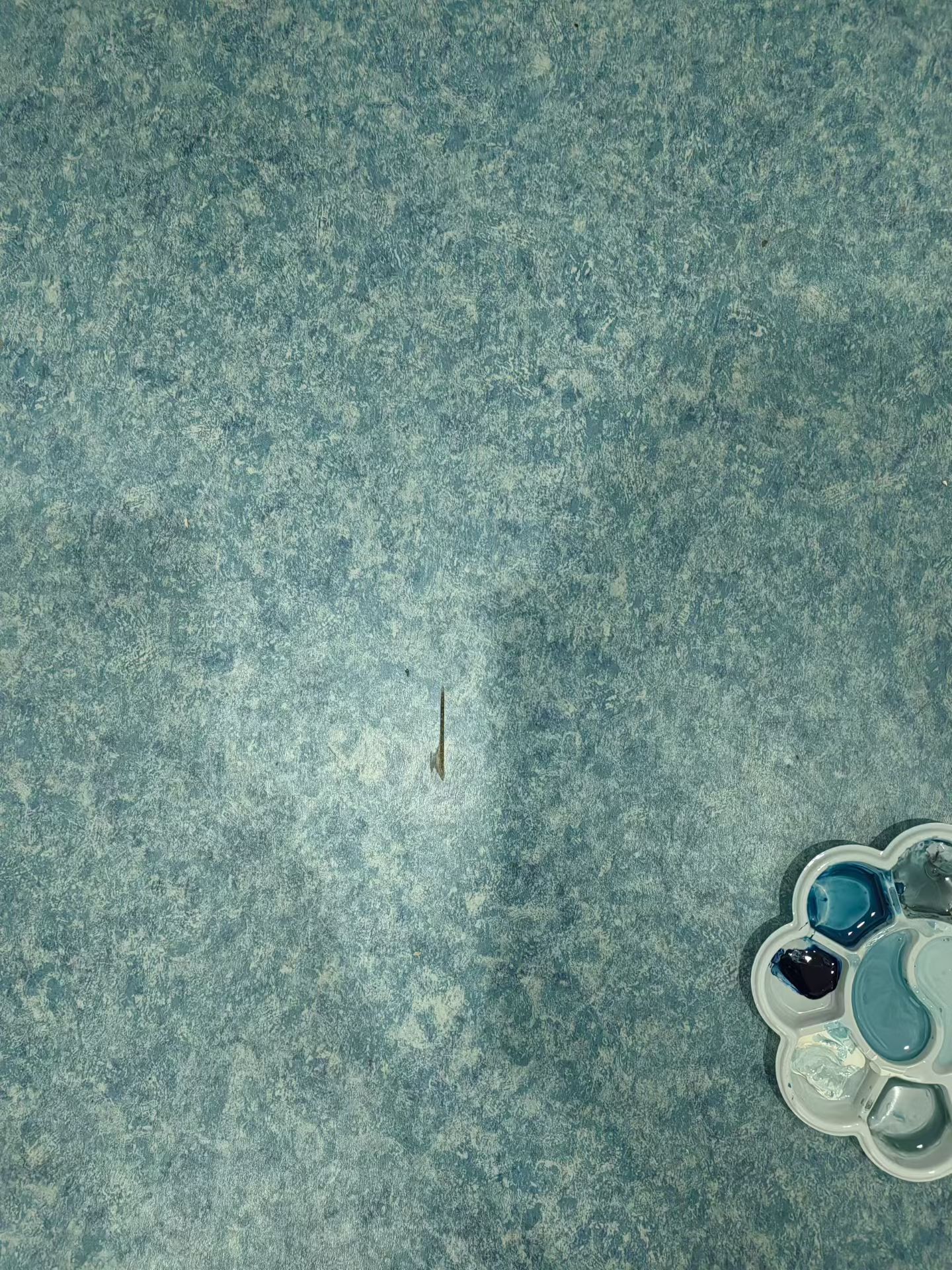Patterned Surface Chip Repair — Before: A visible chip in the patterned surface before repair.