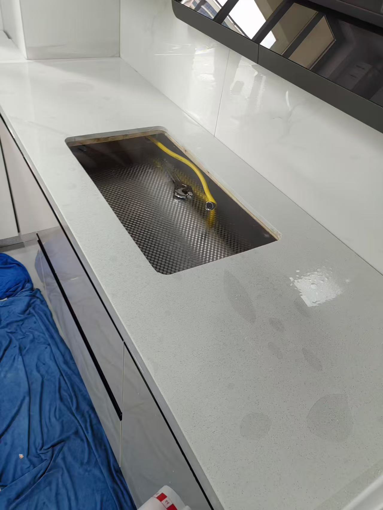 Marble Protection - Photo 5 — Project Photo: Kitchen sink surround during protective film installation.