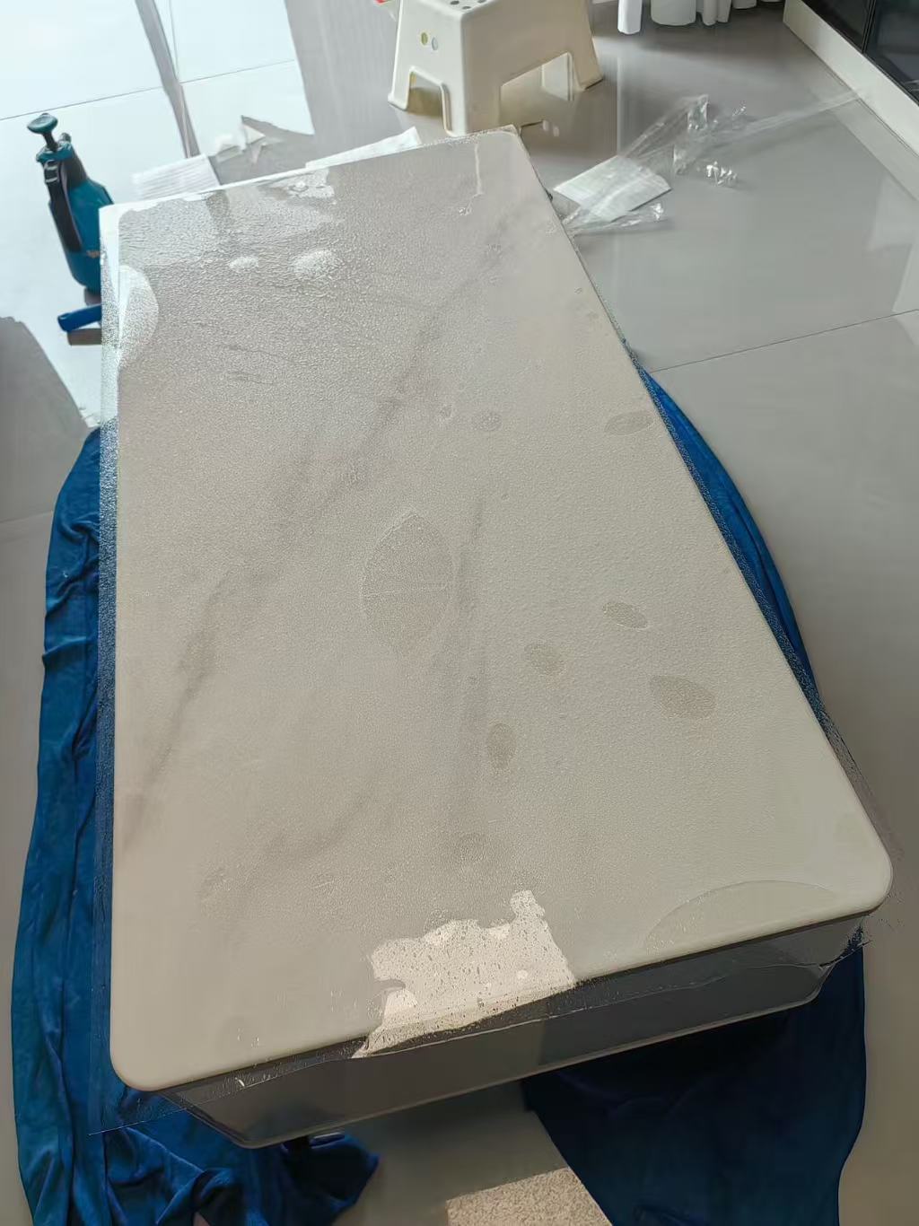 Marble Protection - Photo 13 — Project Photo: Light-coloured coffee table during protective film installation.