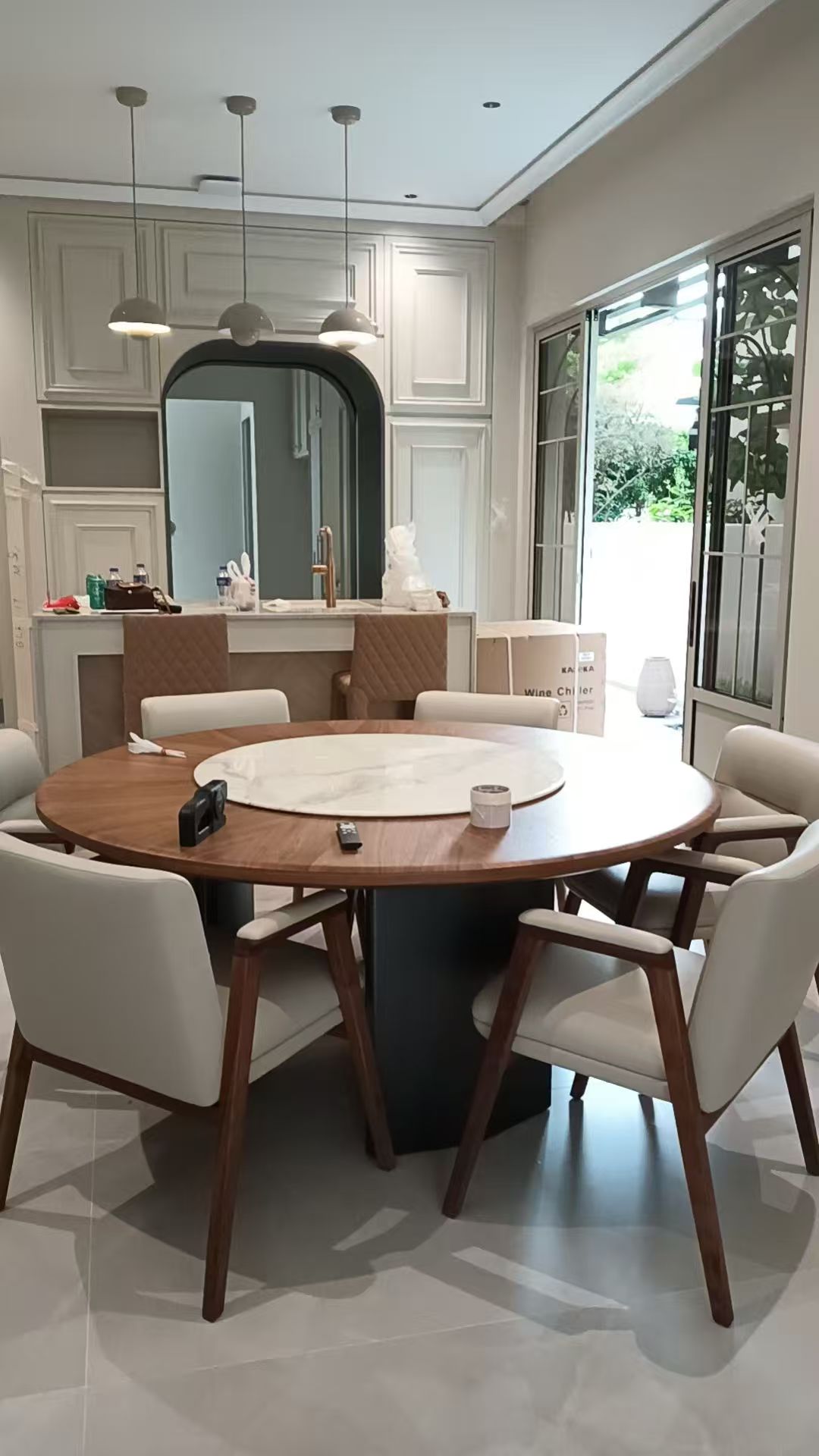 Custom Carpentry & Installation - Photo 1 — Project Photo: Dining area with fitted cabinetry and a round dining table.