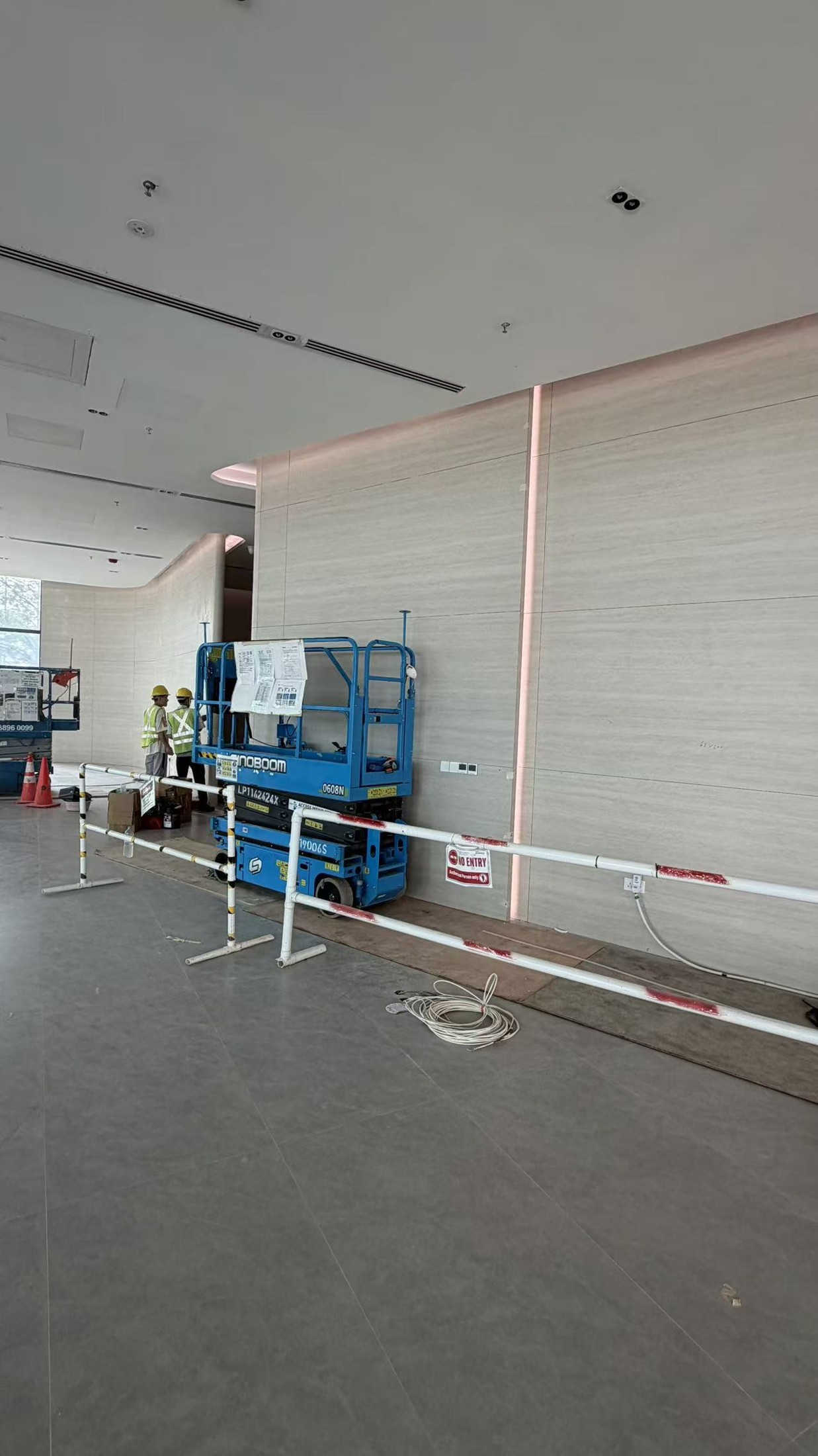 Tile Grouting - Commercial Wall and Floor Project — In Progress: Commercial wall tiling with on-site access equipment.