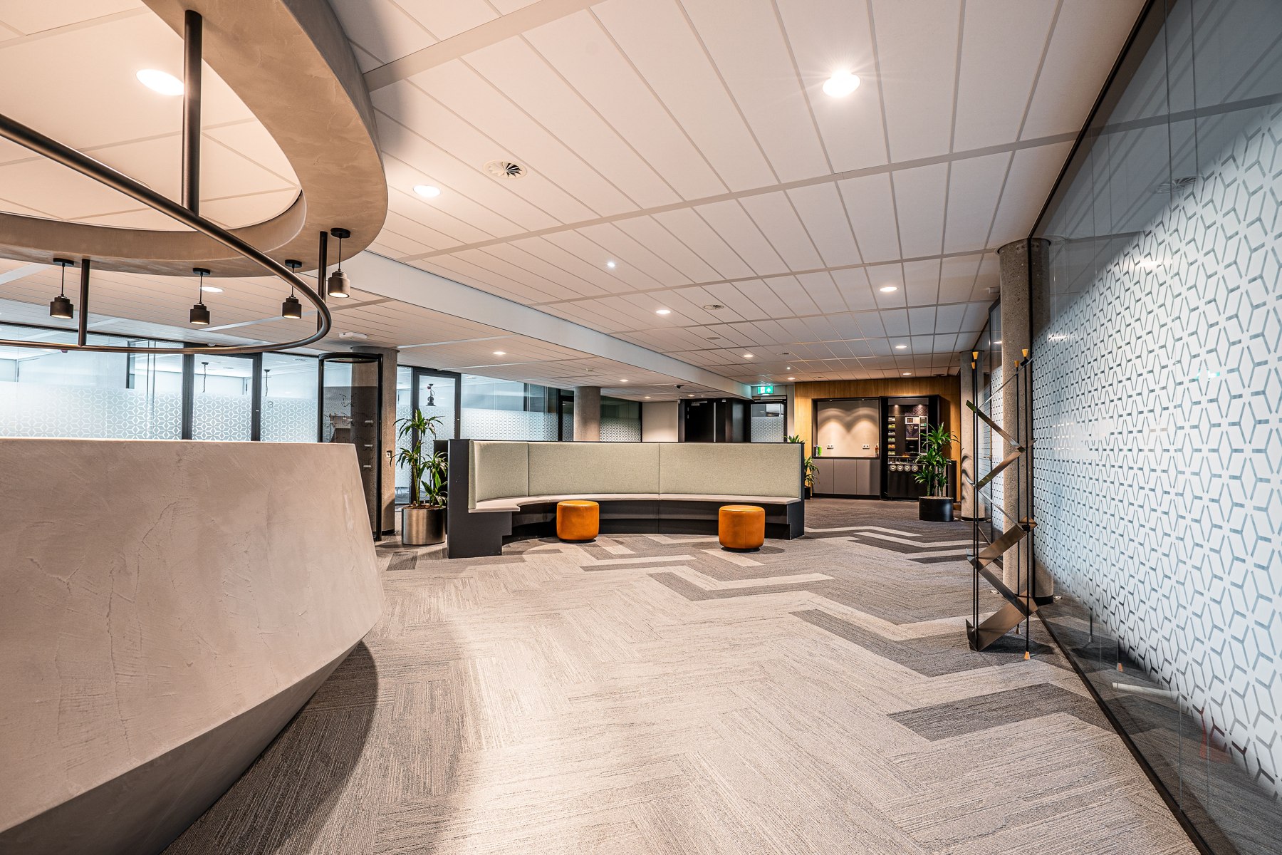 Commercial reception area with a counter, seating and finished floors — illustrative stock photo